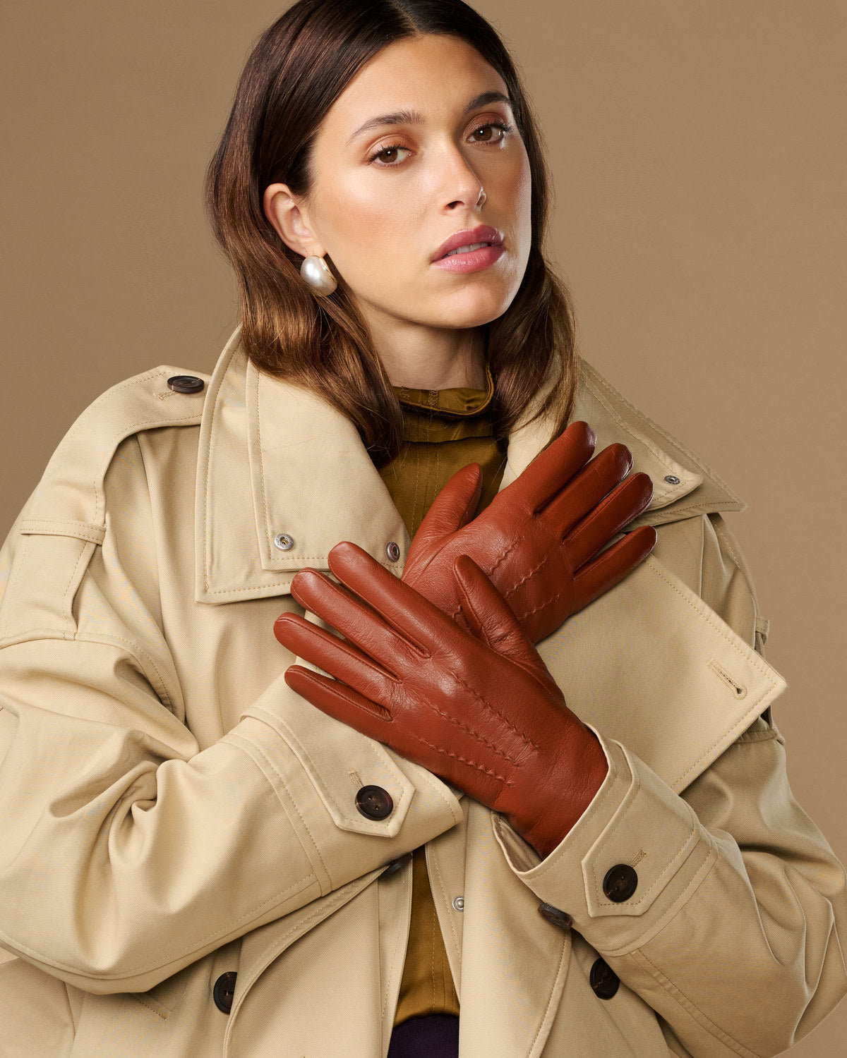 Cognac brown goatskin leather gloves with stitched details and snug fit