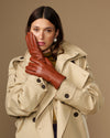 Cognac brown goatskin leather gloves with clean seams and five-finger design
