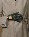 Dark green leather gloves with buttoned finger cutouts and slim wrist tabs