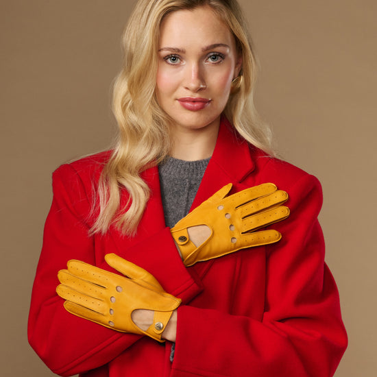 Yellow lambskin driving gloves with perforations and touchscreen fingertips