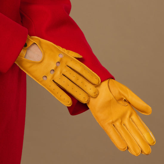 Yellow lambskin driving gloves with perforated knuckles and long cuff