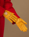 Yellow lambskin driving gloves with perforated knuckles and long cuff