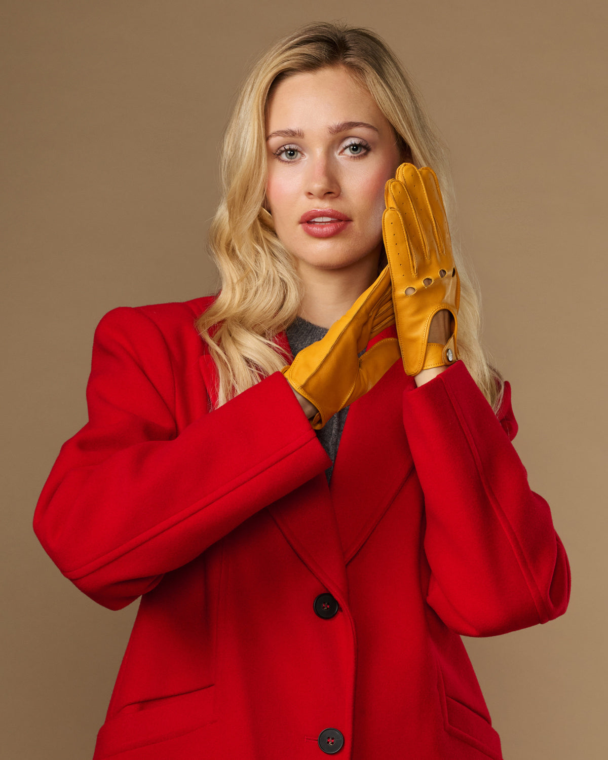 Yellow lambskin driving gloves with perforated seams and touchscreen fingertips