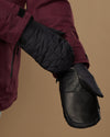 Black mitten with a leather palm panel and quilted back.