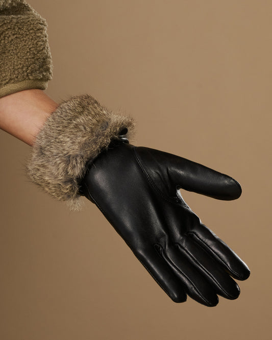 Black leather gloves with plush gray fur lining and touchscreen finger tips