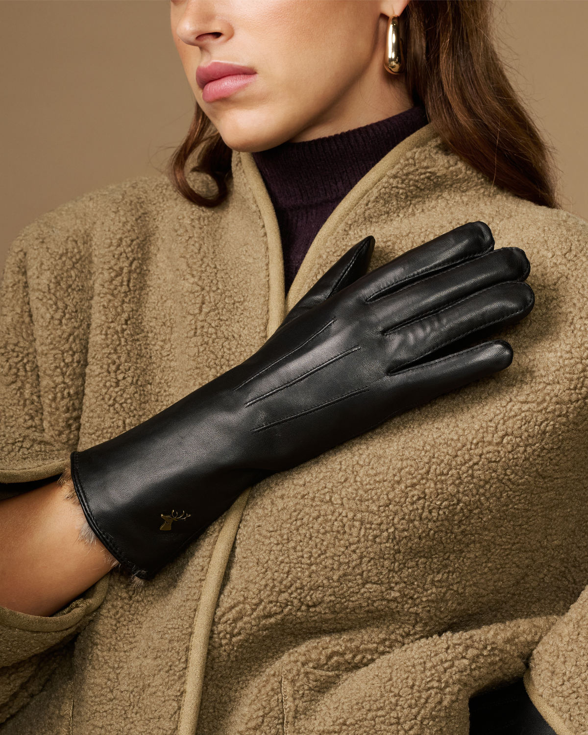Black leather gloves with long sleeves, fur lining at wrist, and touch icon