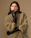 Black leather gloves with long cuffs and fur lining, touchscreen detail at palm