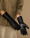 Pair of black leather gloves with plush fur-lined cuffs and touchscreen tips