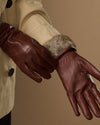 Brown leather glove cuff with visible rabbit-fur lining and seam details
