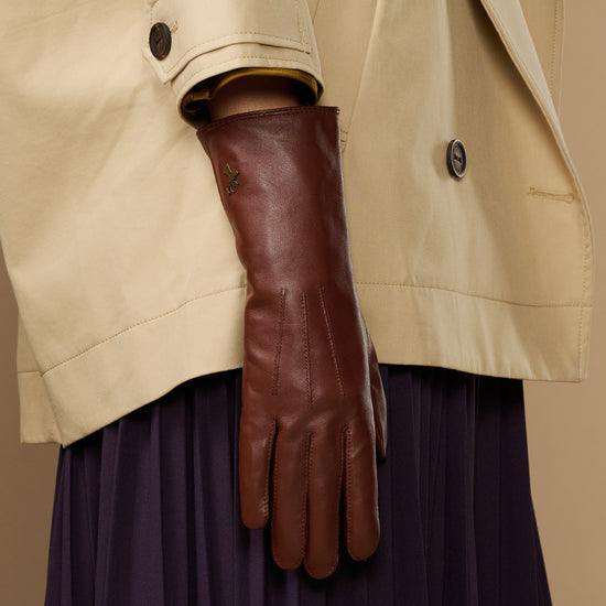 Extra-long brown leather gloves showing cuff edge with rabbit-fur lining