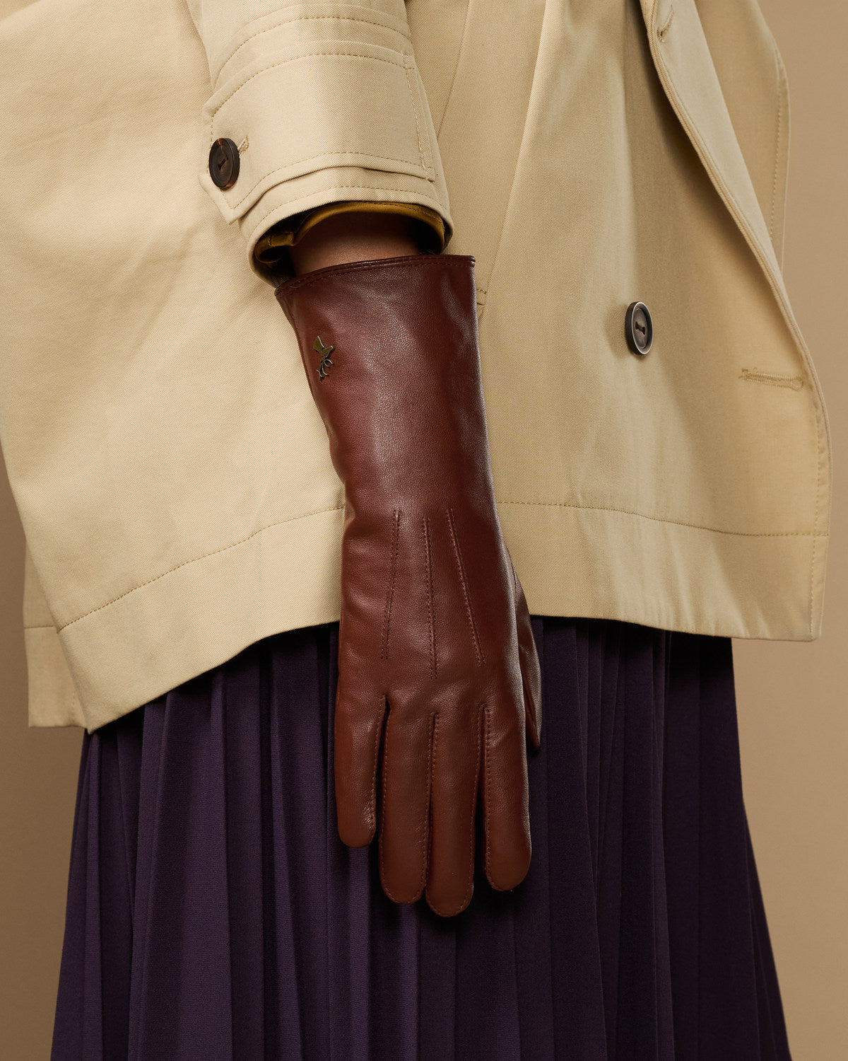 Extra-long brown leather gloves showing cuff edge with rabbit-fur lining