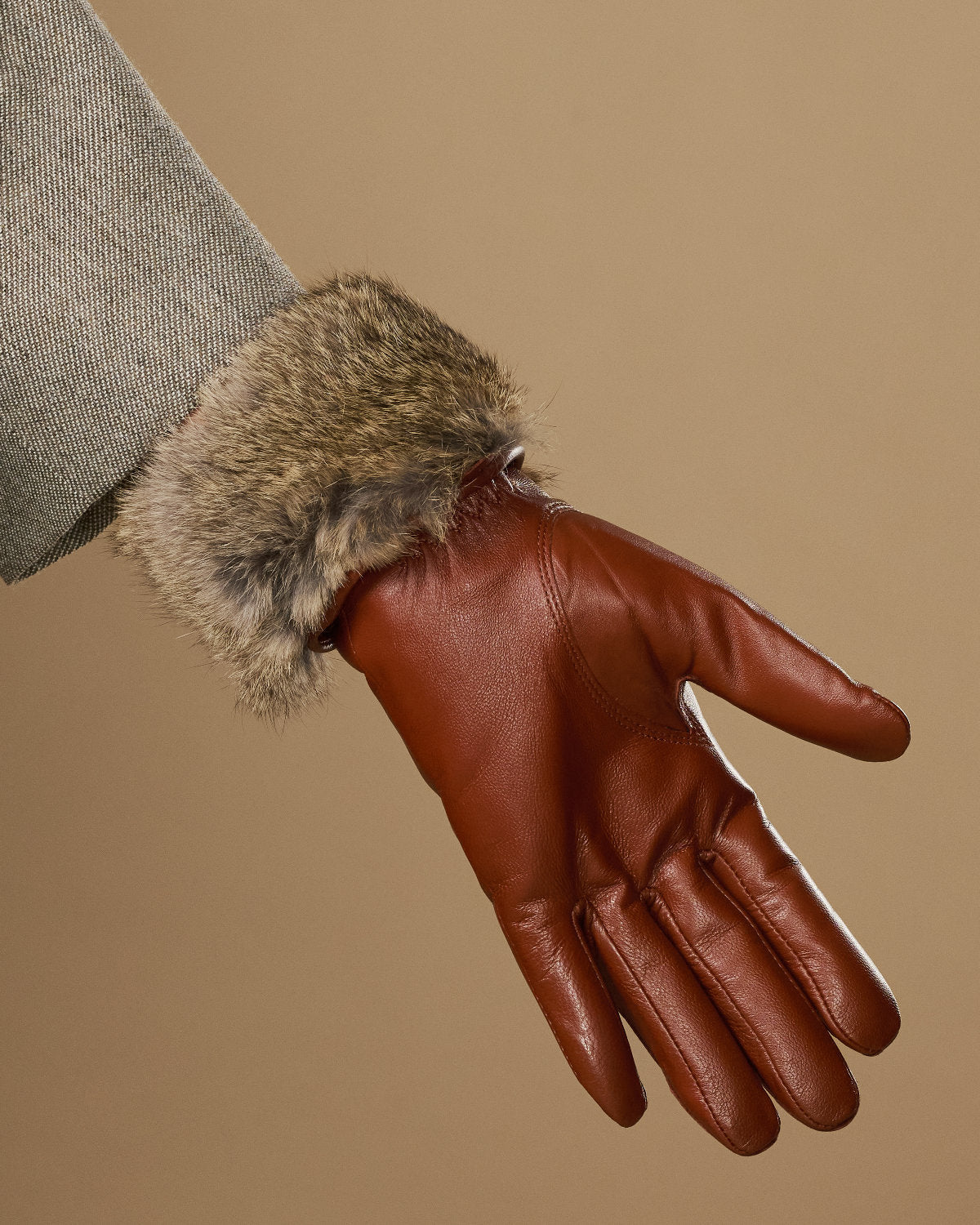Extra-long cognac leather glove with soft rabbit-fur cuff, close-up