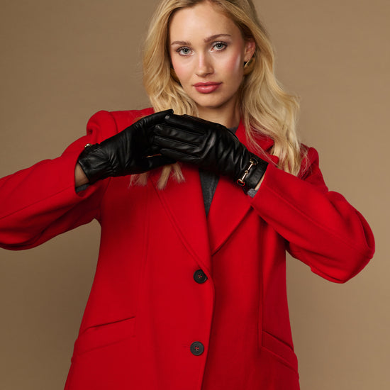 Black leather gloves with gold-tone buckle and stitched finger seams