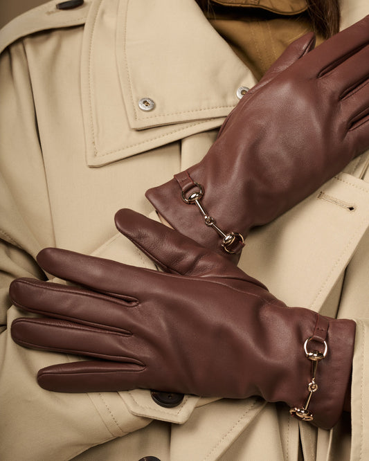 Dark brown lambskin gloves with gold-tone buckle hardware and shaped finger panels