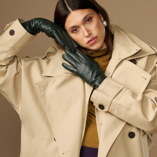 Dark green leather long gloves covering hands and wrists in a close-up
