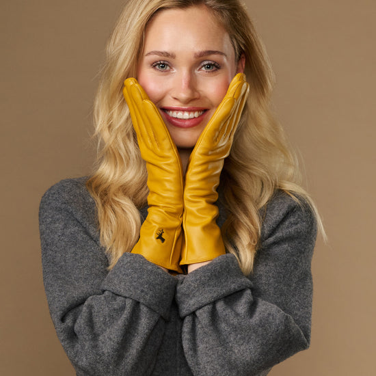 Yellow extra-long leather gloves with cashmere lining; cuff logo; touchscreen fingertips at wrists
