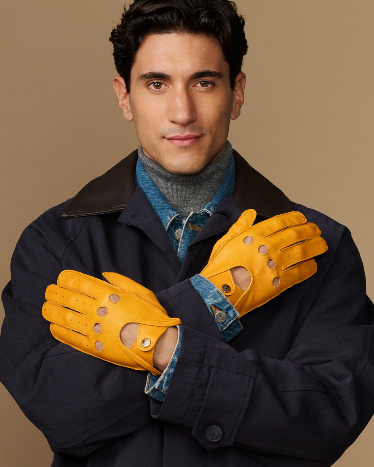 Pair of men's yellow lambskin driving gloves with denim lining and perforated knuckles
