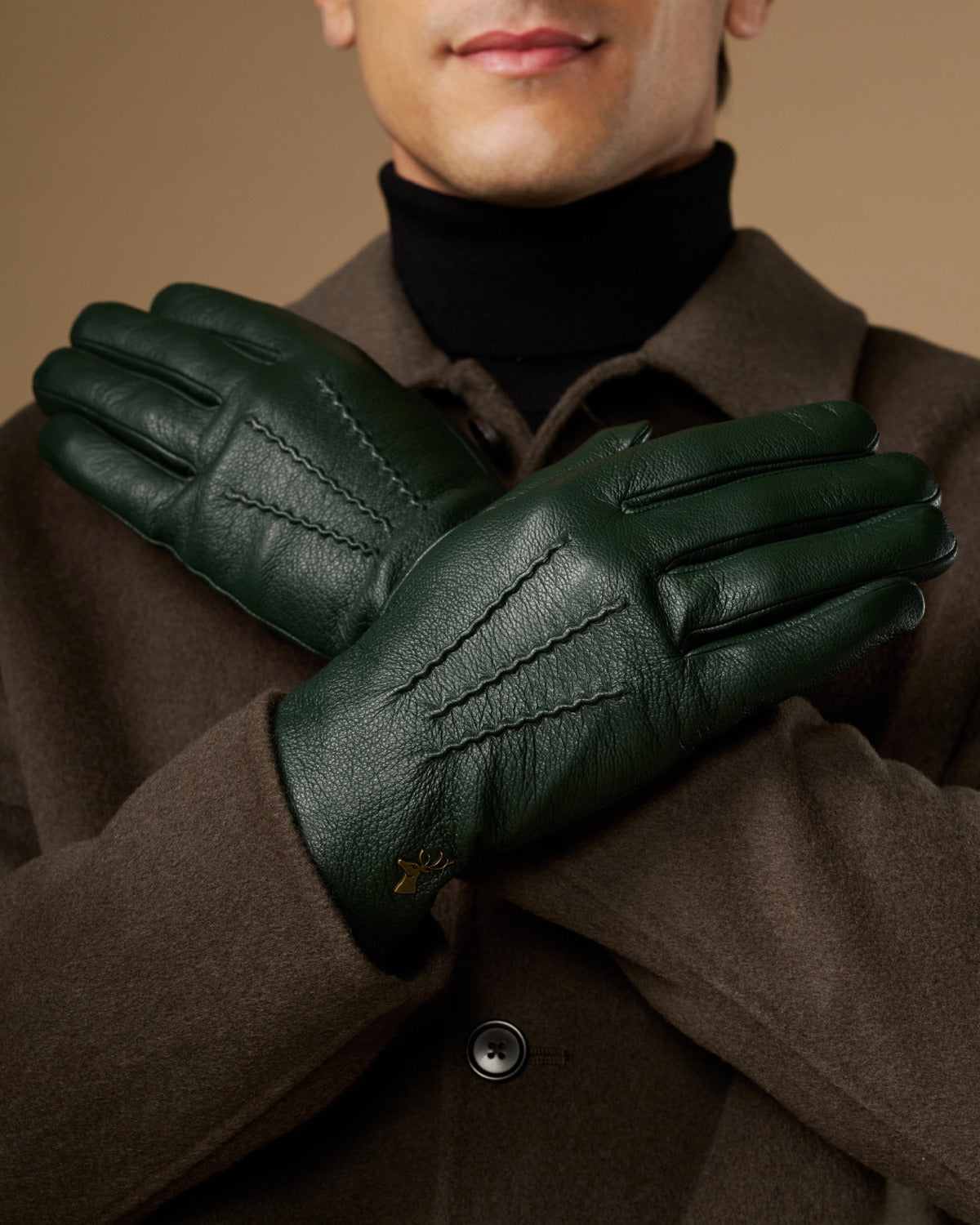 Men's dark green leather gloves with stitched details, wool-lined cuffs