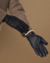 Men's navy goatskin leather gloves with wool lining, side view of knuckles and cuff