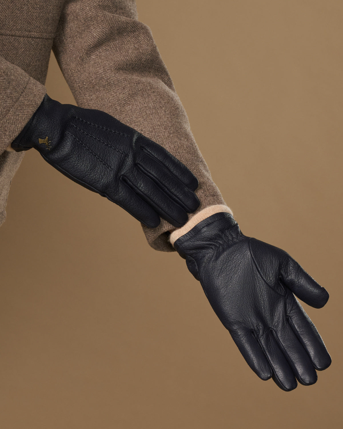 Men's navy goatskin leather gloves with wool lining, side view of knuckles and cuff