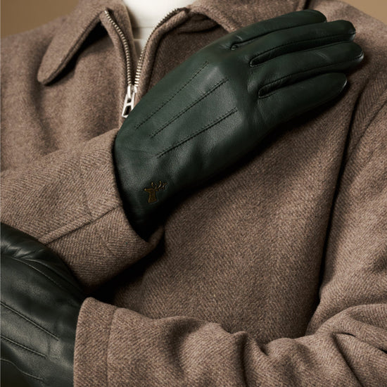 Dark green Jake sheepskin gloves with warm fleece lining, close-up on hand