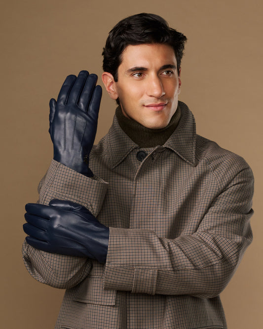 Navy leather gloves with stitched fingers, worn by a man in a plaid coat