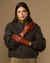 Women’s cognac leather gloves with fur-lined cuffs and snug wrist fit