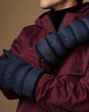 Blue down mittens with padded quilting, round logo patch on the wrist