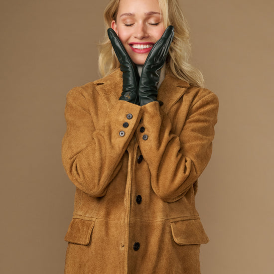 Dark green leather gloves with silk lining, finger seams, and touchscreen-compatible tips
