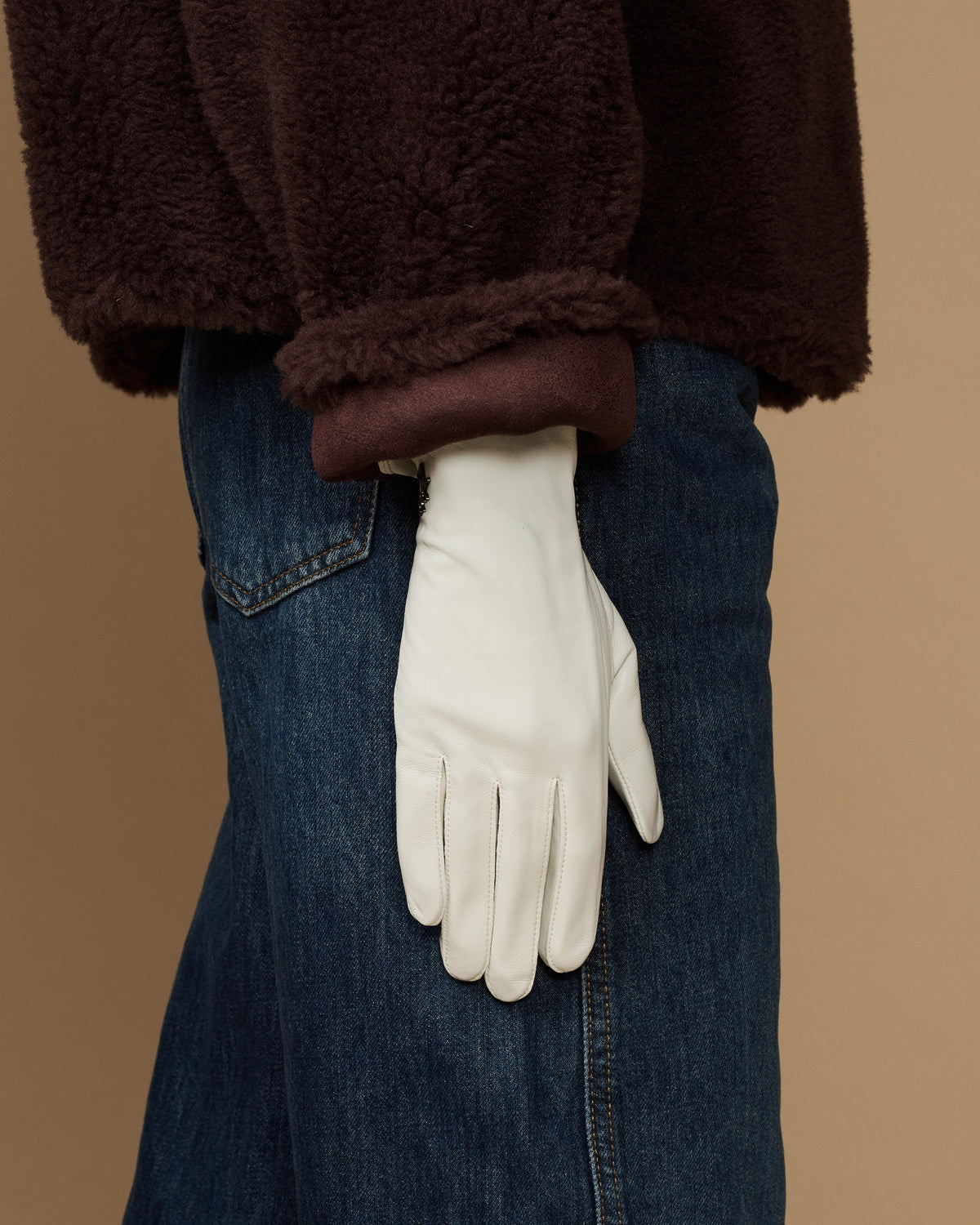 White leather glove with clean wrist seam and full hand coverage, tapered cuff