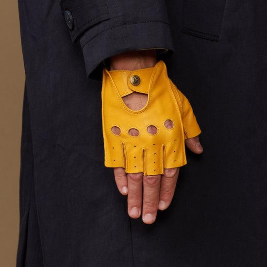 Yellow fingerless glove with snap wrist cuff, perforated finger and knuckle panels