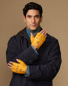 Yellow fingerless driving gloves with perforated panels, palm-forward hand pose