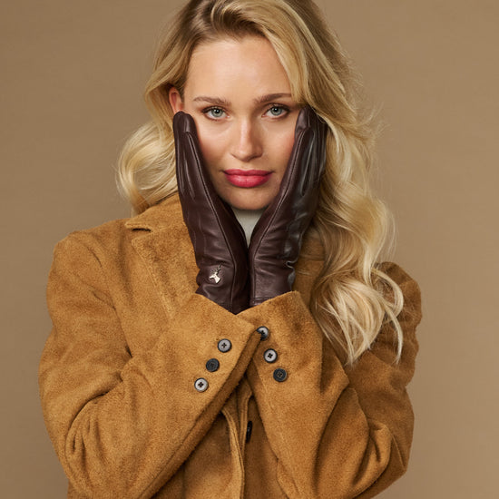 Brown fleece-lined leather gloves, knuckle detail visible while worn