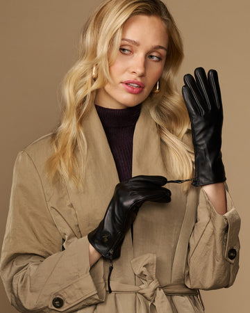 Black lambskin leather gloves with side zipper, worn by a model