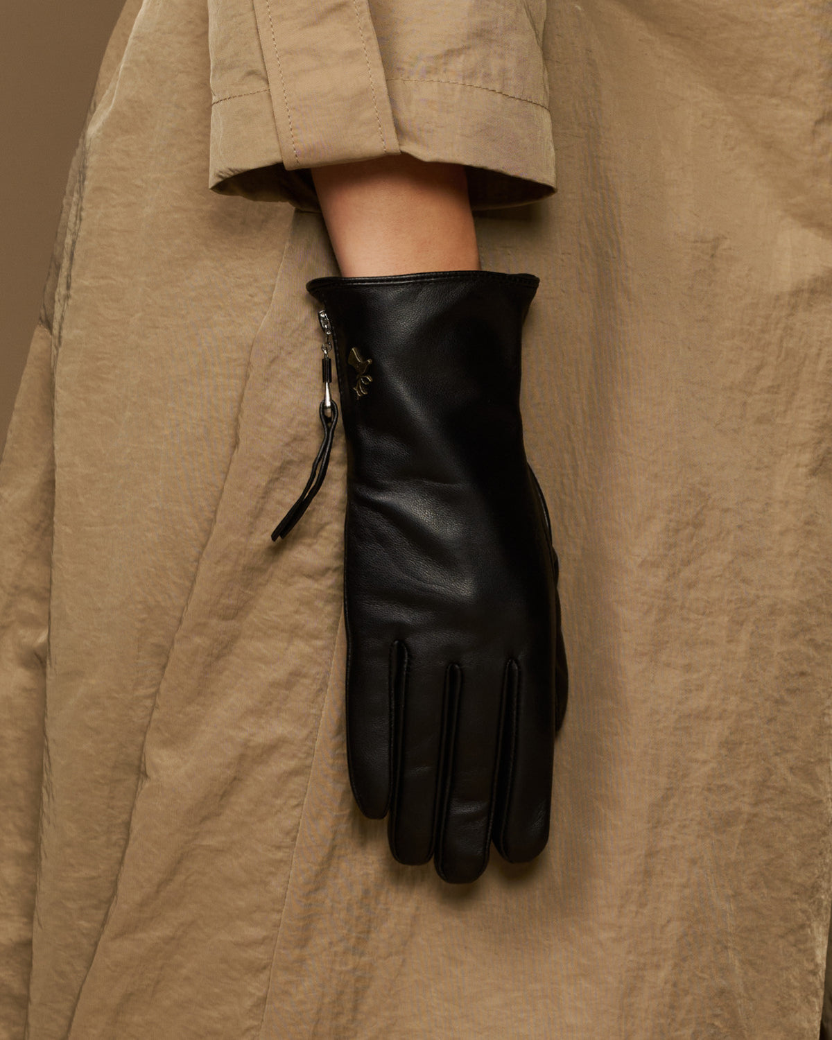 Black lambskin leather glove with side zipper, hanging display