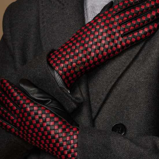 Close-up of women's black gloves with red-and-black checkered palm and fingers