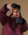 Men's insulated touchscreen gloves in dark gray, worn with hooded jacket