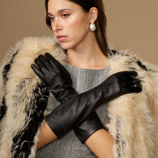 Black below-elbow leather gloves with touchscreen fingertips, glossy finish, ruched cuff