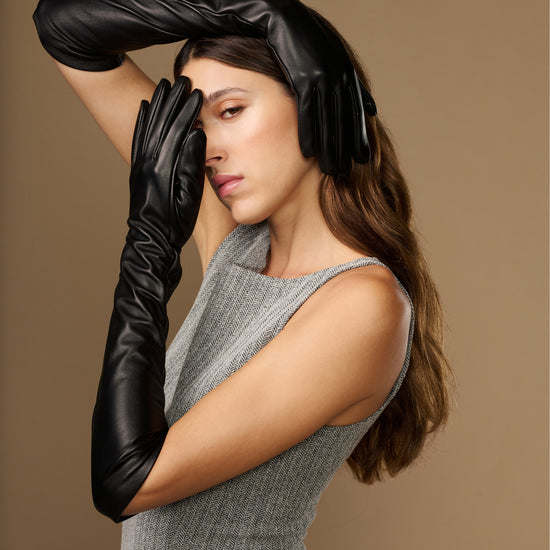 Women’s black leather elbow gloves, close-up of cuffs and knuckle area