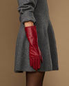 Red leather mid-forearm gloves with long cuff and stitched finger panels