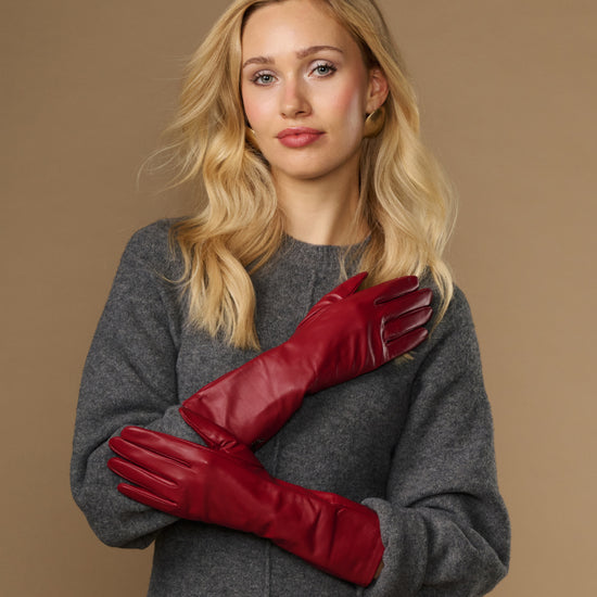 Red leather mid-forearm gloves with stitched fingertips and streamlined cuff seams