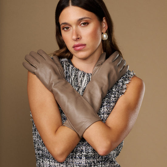 Taupe lambskin leather gloves, below-elbow fit, tapered fingers and slim cuff detail.