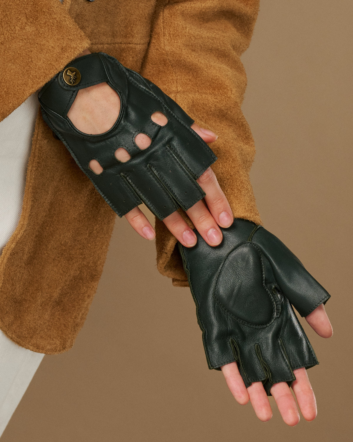 Dark green fingerless lambskin driving gloves with oval thumb cutout and seams