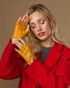 Yellow fingerless driving gloves with thumb opening and studded knuckle panels