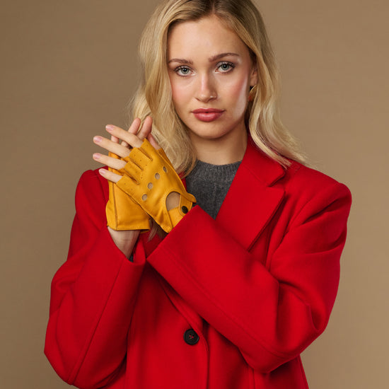 Yellow women's fingerless lambskin gloves with perforated knuckles and snap cuff