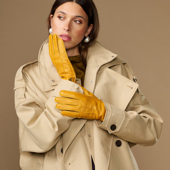 Yellow deerskin leather gloves with stitched finger panels and shaped wrist cuff