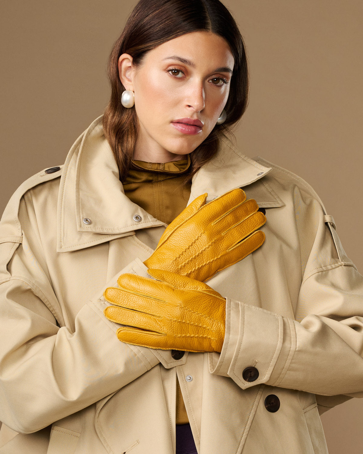 Yellow deerskin leather gloves with stitched knuckles and snug wrist cuff