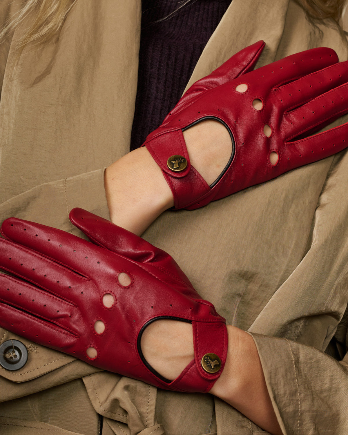 Red leather driving gloves close-up, perforated fingers with thumb cutout