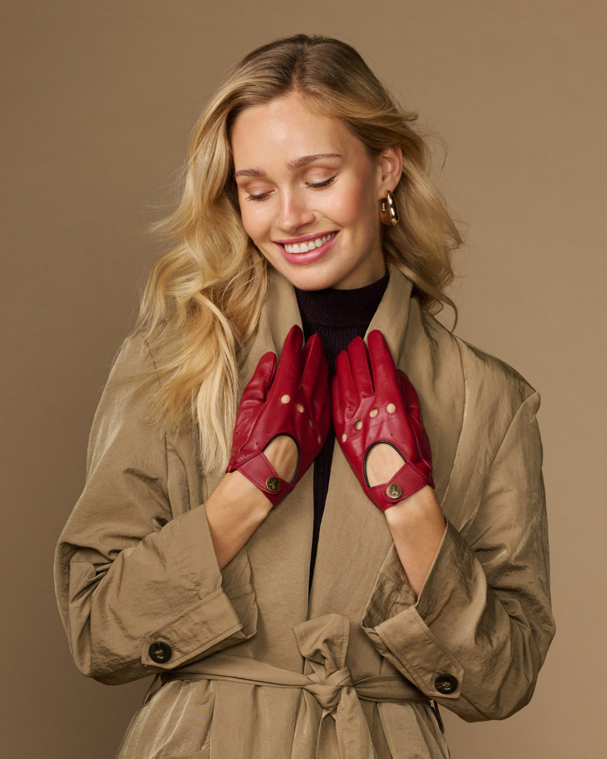 Women’s red leather driving gloves with perforations and button-detail cuff