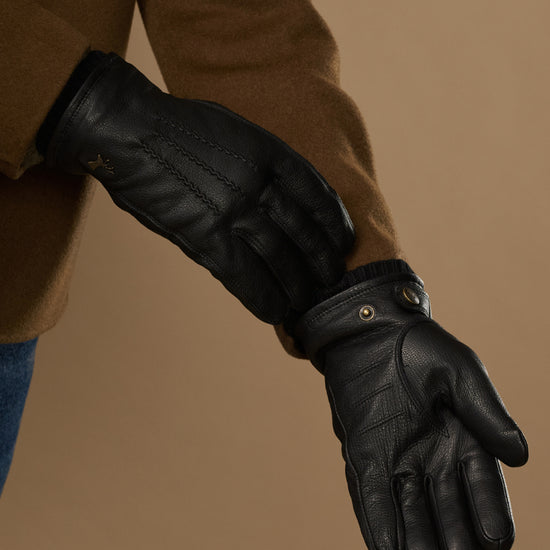 Black goatskin leather gloves with warm lining visible at cuff and press-stud